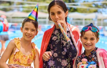 Children at a birthday party under outdoor shaded area